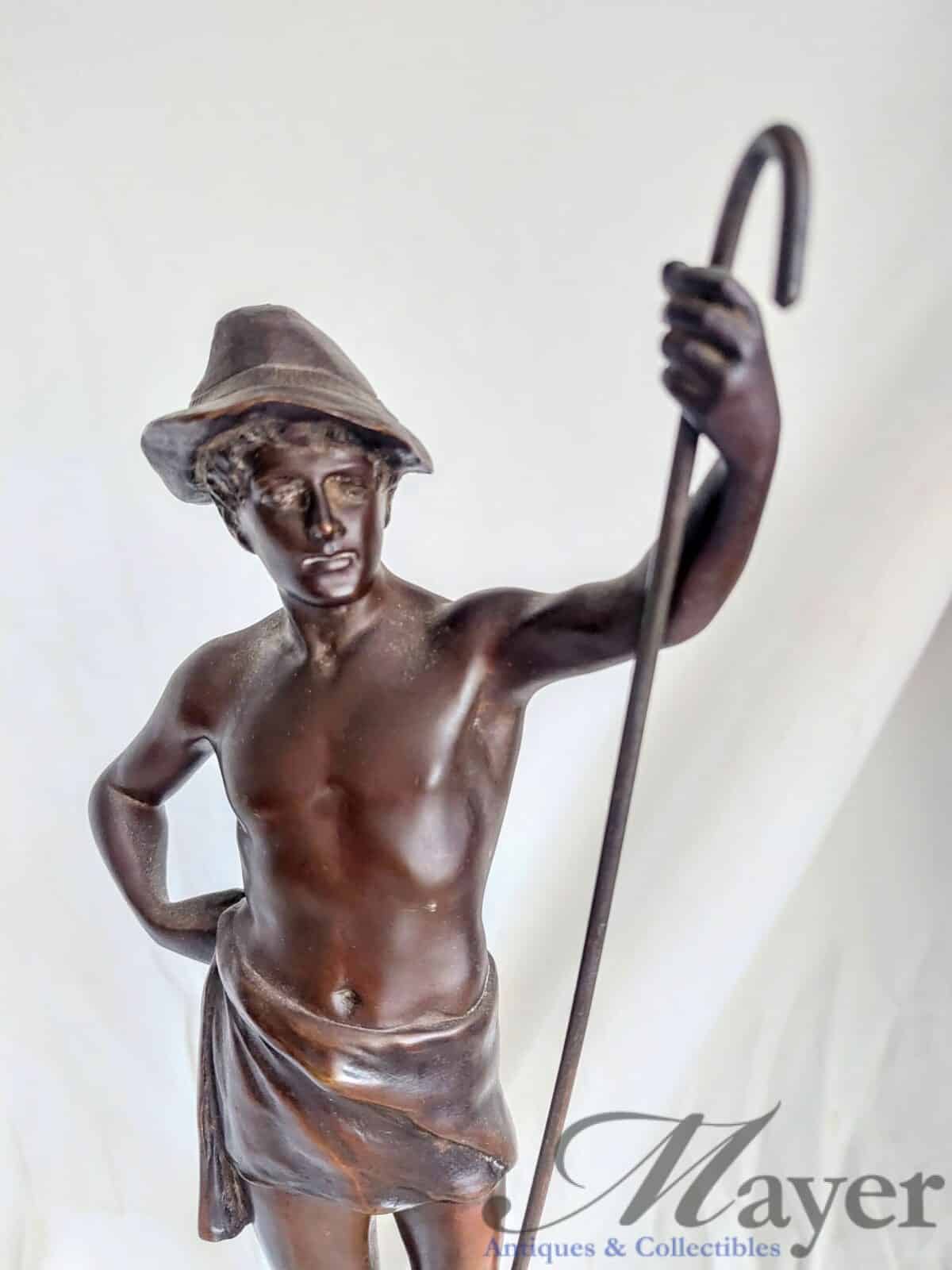 The shepherd boy (Le berger in French) by Raphael Hubert, a dark brownish patinated bronze sculpture from around the 1920's. 