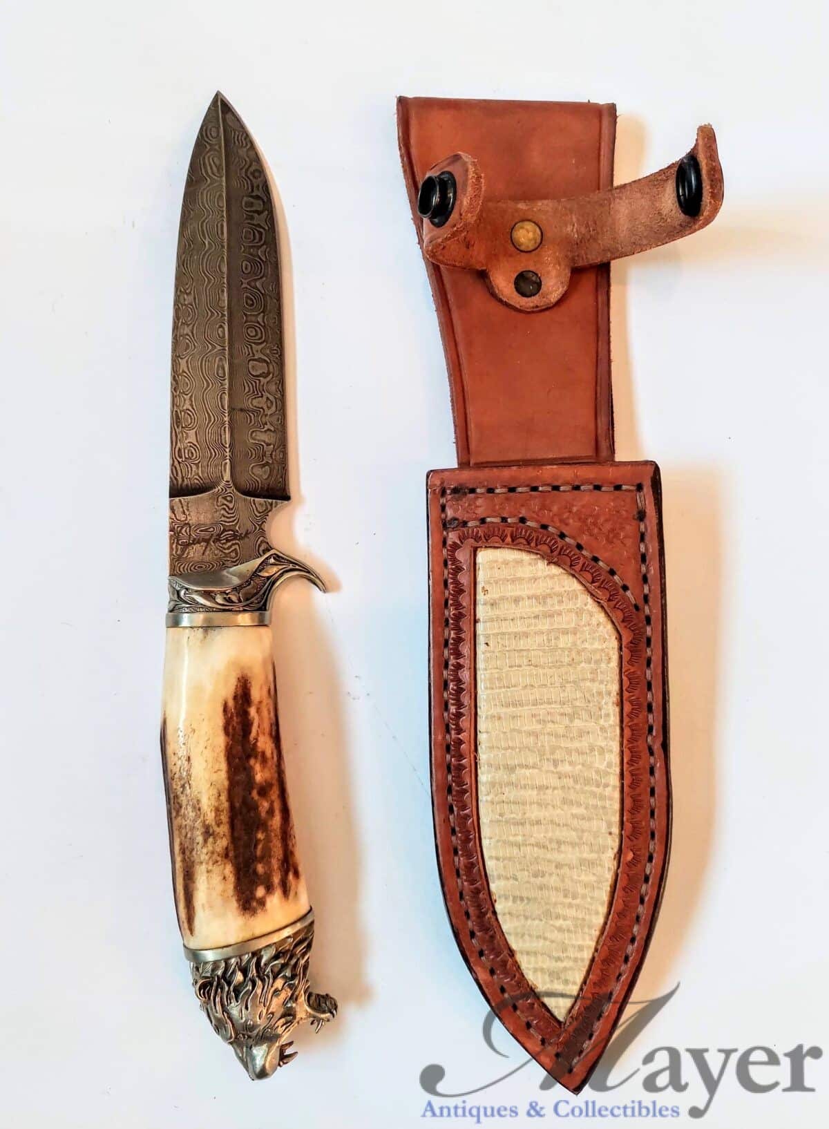 Knife with lion head and Jerry Fisk marked Damascus blade with leather scabbard signed by Alex Shamgar of Dustar knives.