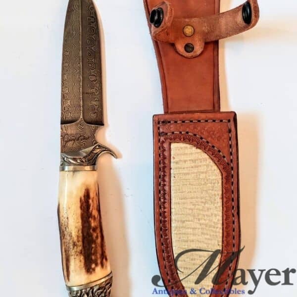 Knife with lion head and Jerry Fisk marked Damascus blade with leather scabbard signed by Alex Shamgar of Dustar knives.